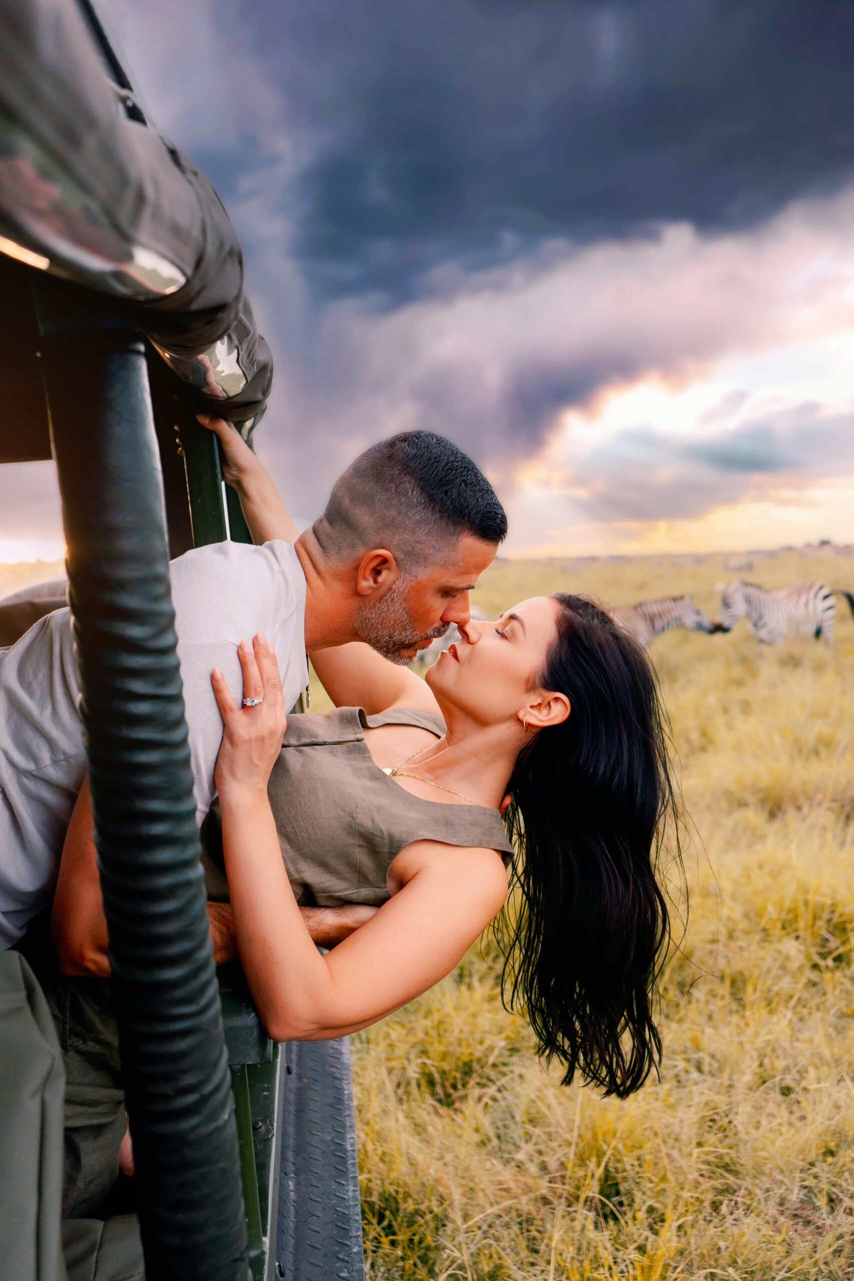 Romantic couple kissing during a safari adventure in Nairobi, Kenya.